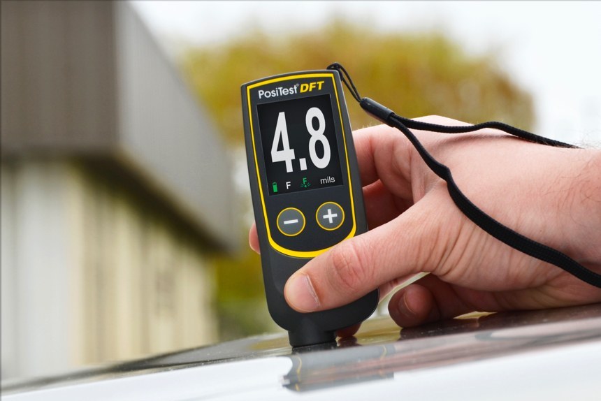 PosiTest DFT in ferrous mode measuring paint thickness on an automobile hood