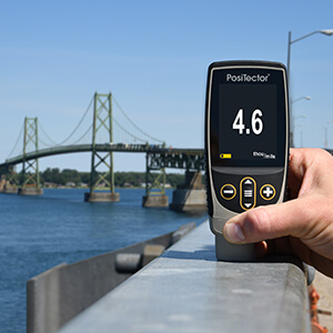 Handheld instrument used for coating thickness measurement on industrial surfaces