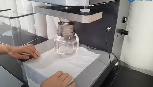Fabric specimen secured in a bursting strength test fixture