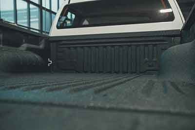 Spray-on bedliner coating inside a truck bed