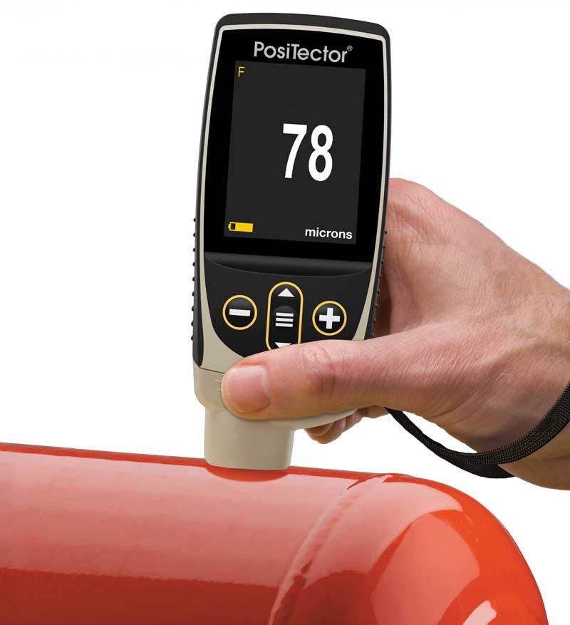 PosiTector 6000 measuring coating thickness on a coated metal tank