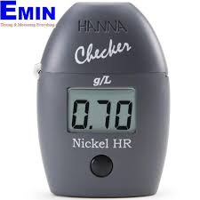 Technician checking a nickel measuring instrument during inspection